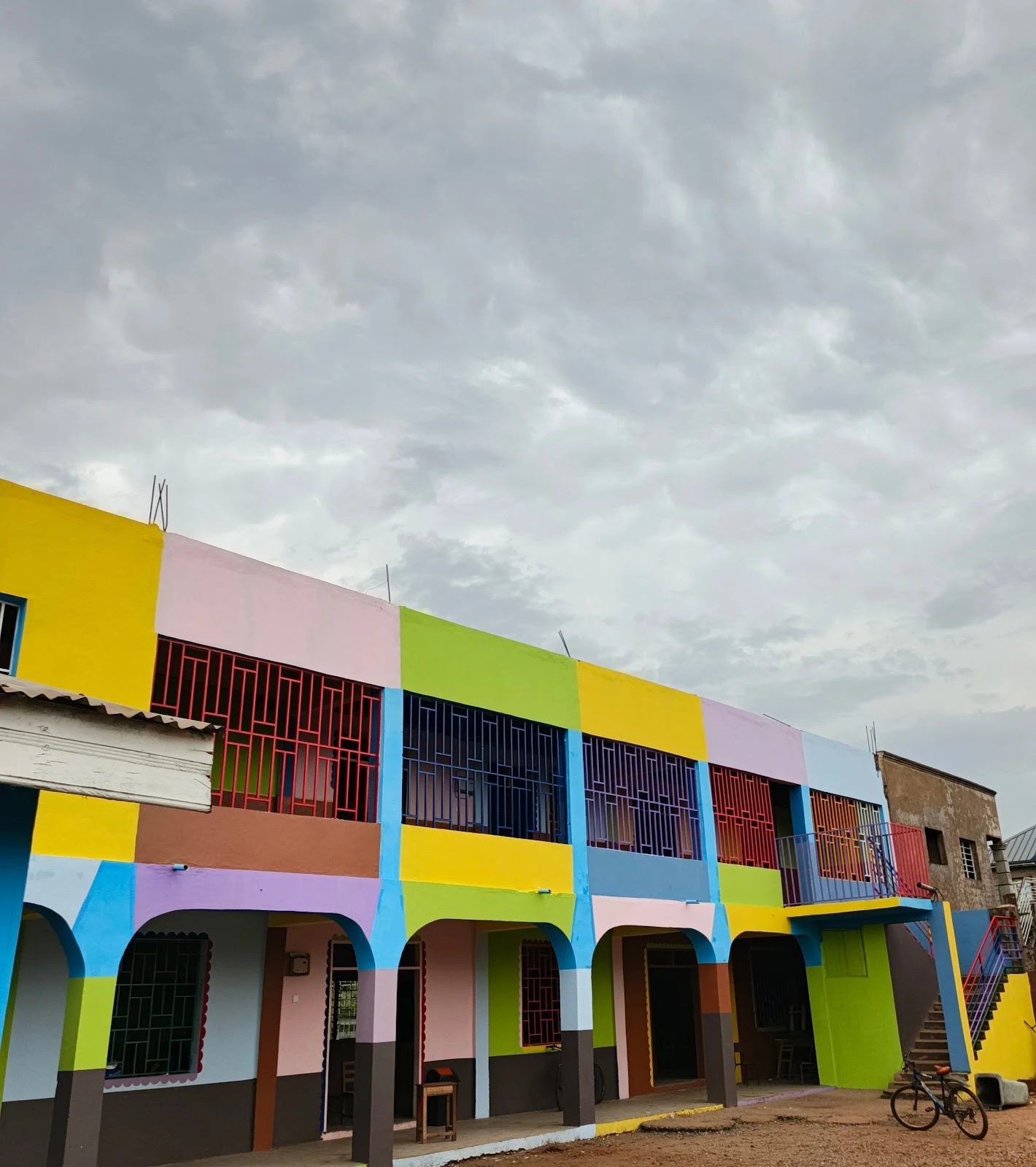 The brightly painted main classroom block at Macvak Kids Academy